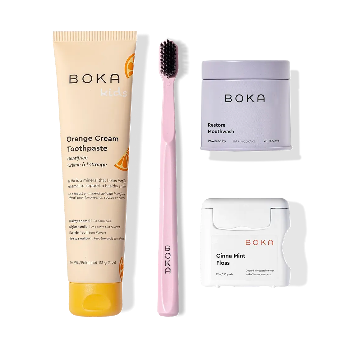 Boka Advanced Kit: orange cream toothpaste, kids-safe, pink brush, floss, and mouthwash tablets.