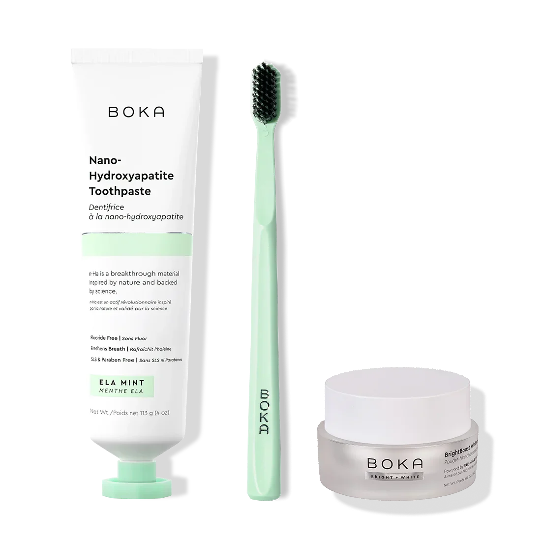 Boka toothpaste, toothbrush, and whitening powder on a white background