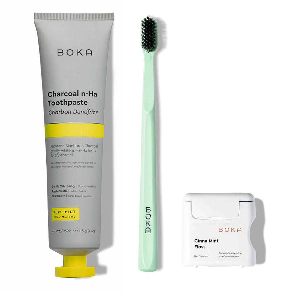 Classic Kit: toothpaste tube, mint toothbrush with charcoal bristles, and teflon-free floss on white.