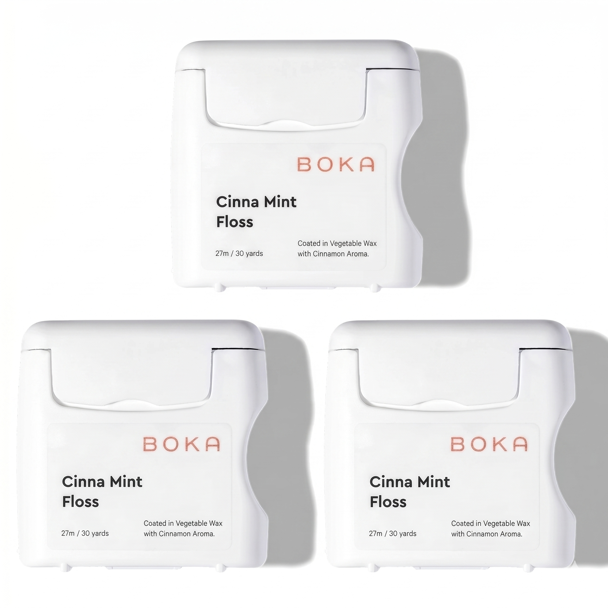 Three packages of Boka Cinna Mint Floss on a white background