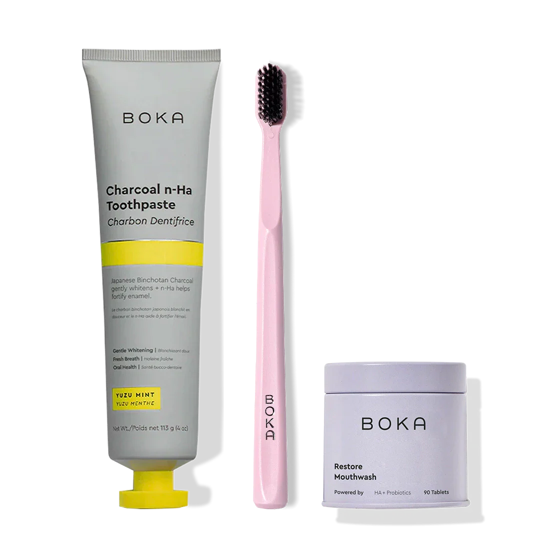 Fresh Faced toothpaste, pink toothbrush with charcoal bristles, and Restore Mouthwash tablets.