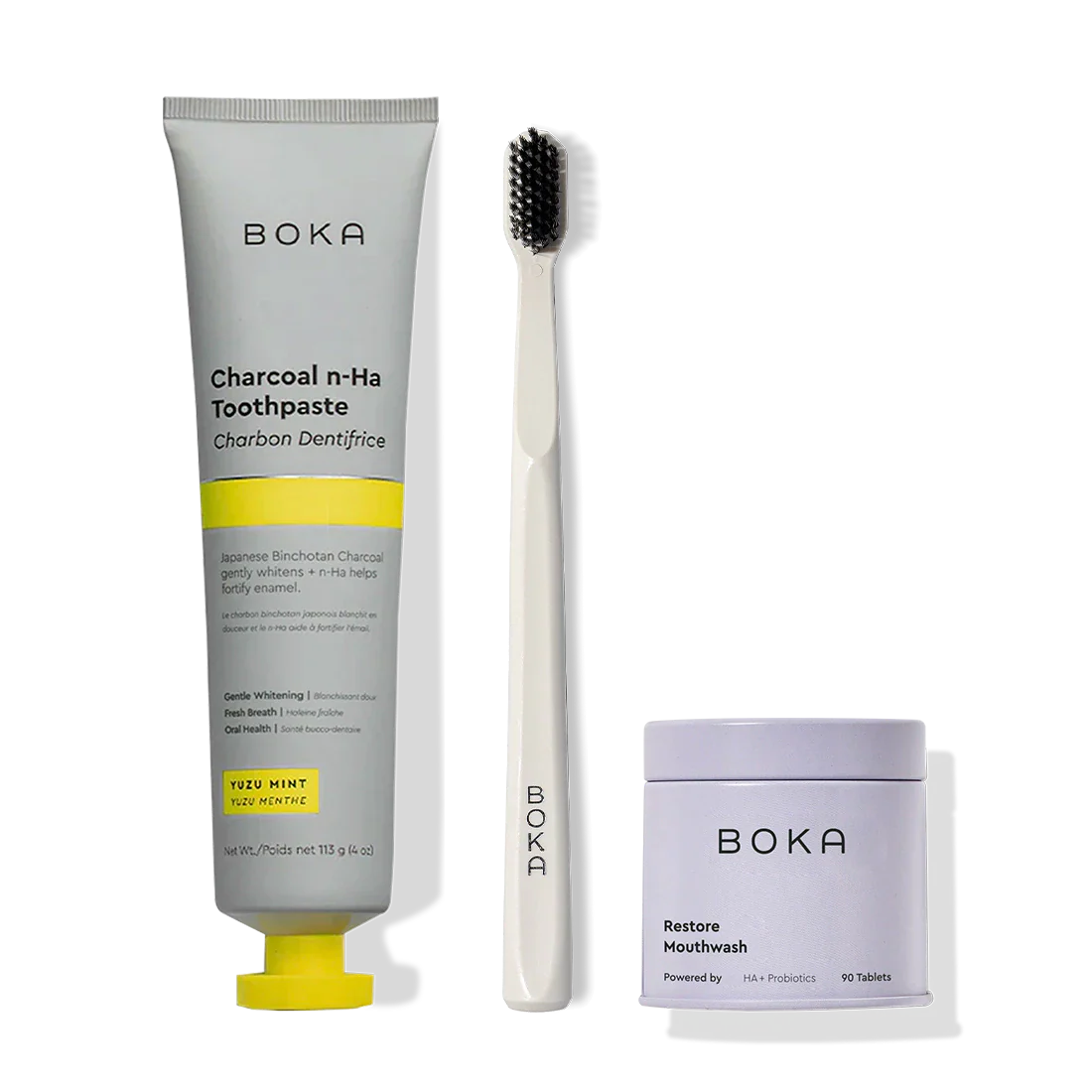 Fresh Faced: toothpaste, white brush with charcoal bristles, and Restore Mouthwash tablets.