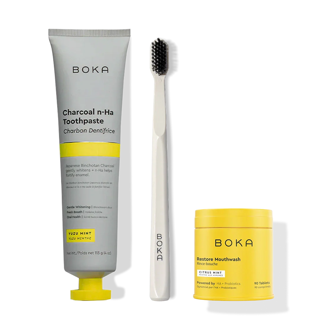 Fresh Faced Toothpaste, white brush with activated charcoal bristles, and Restore Mouthwash tablets.