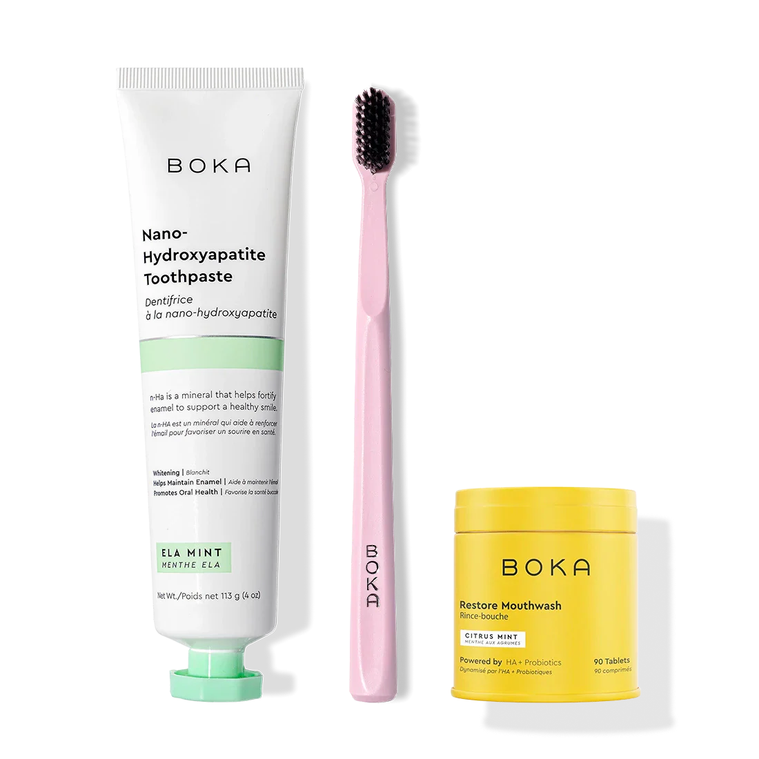Fresh Faced Toothpaste, pink brush with charcoal bristles, and yellow Restore tablets.