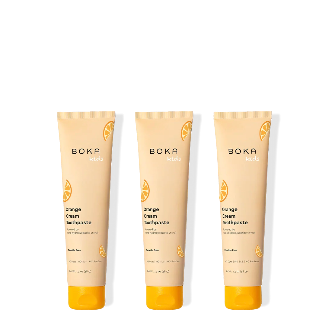 Three tubes of Boka Orange Cream Toothpaste on a white background