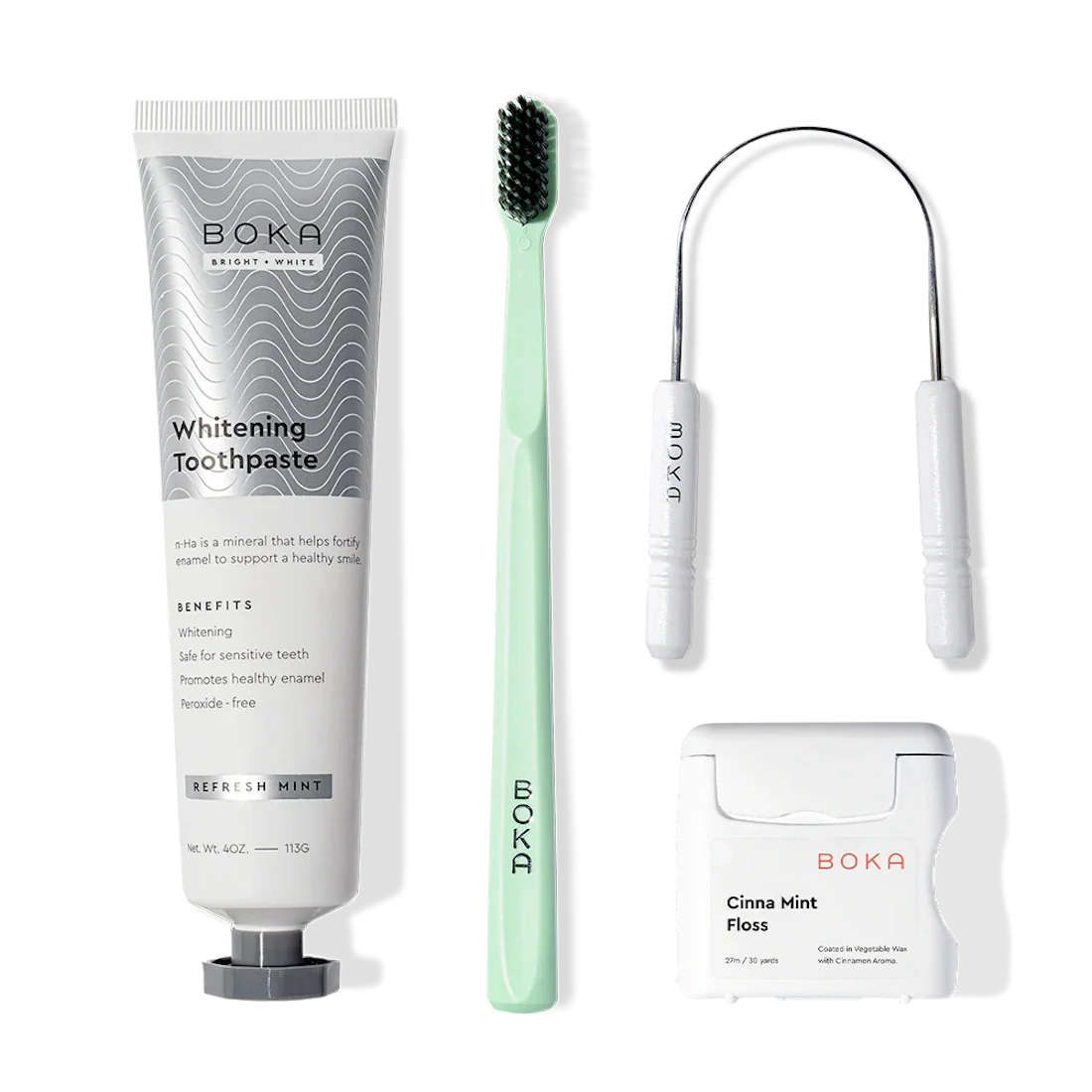 Boka Starter Kit with nano-hydroxyapatite toothpaste, green toothbrush, floss, and pick on white.